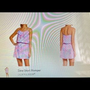 Ruffle trim and skirt complement the seashell print of this sleeveless romper.